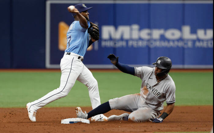 Rays second baseman Vidal Brujan forces out Yankees left fielder Miguel Andujar and throws the ball to 1st base for a double play during the 6th inning at Tropicana Field.
