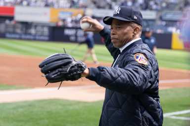 Mayor Eric Adams warms up to throw at Opening Day for the New York Yankees last month.