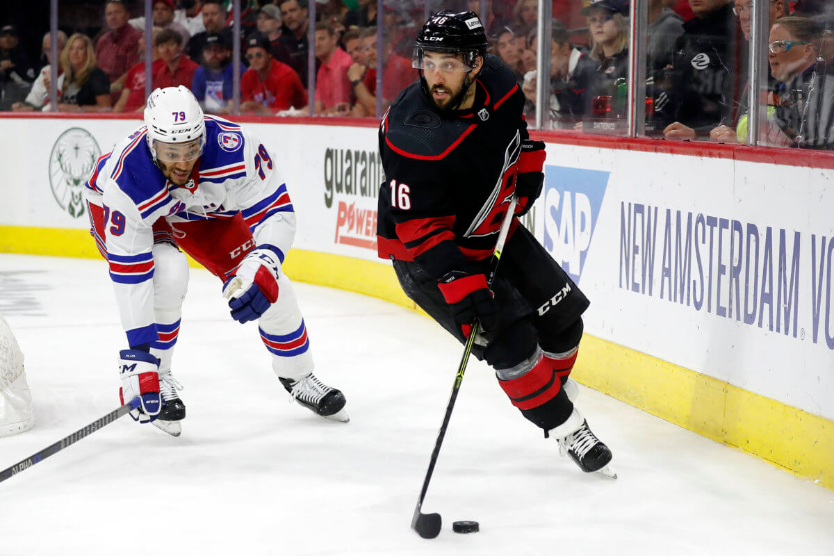 Hurricanes' Vincent Trocheck controls the puck in front of Rangers' K'Andre Miller during the second period of Game 1.