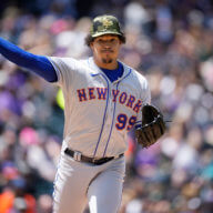 Mets starting pitcher Taijuan Walker turns to make a pickoff-attempt against Rockies' Yonathan Daza in the first inning.