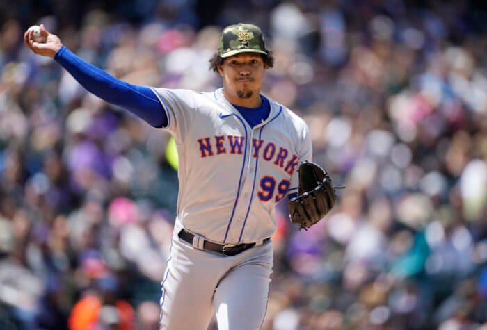 Mets starting pitcher Taijuan Walker turns to make a pickoff-attempt against Rockies' Yonathan Daza in the first inning.