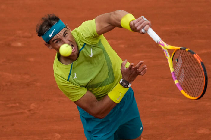 Rafael Nadal serves in the 2022 French Open