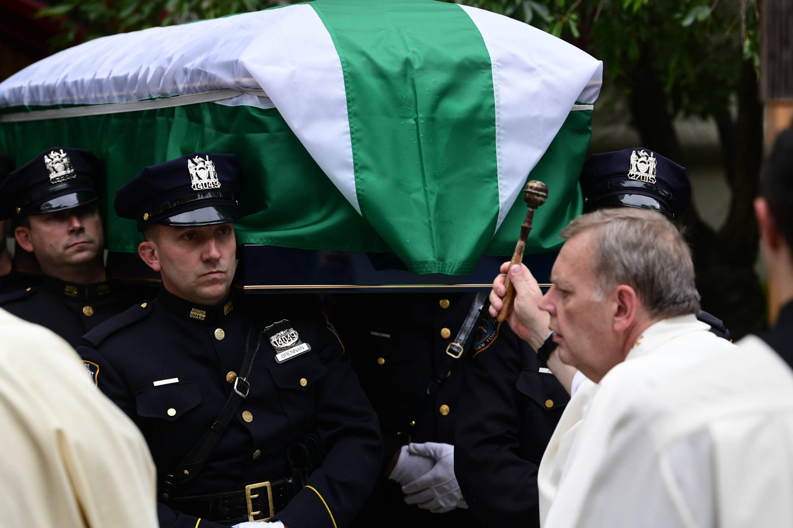 Coffin is blessed by priest