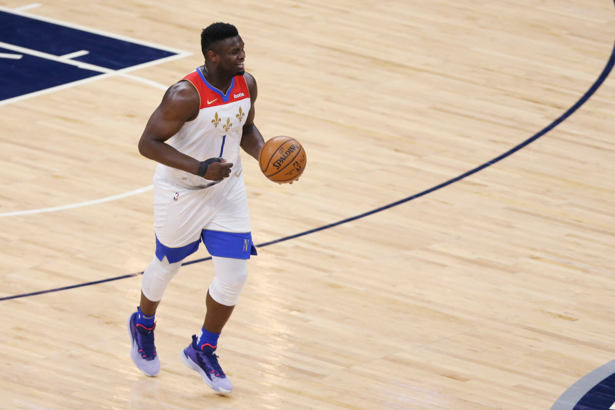 Zion Williamson dribbles up the court.