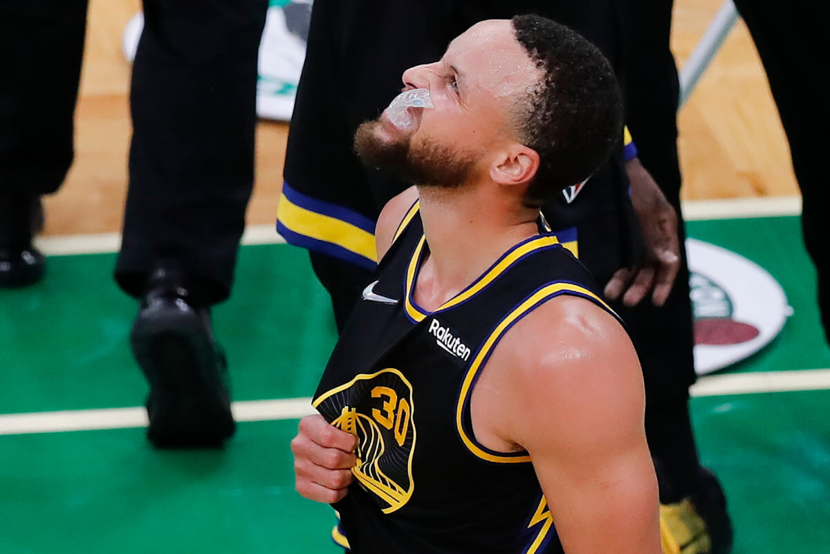 Warriors guard Stephen Curry shakes off an injury after diving for a loose ball in the 4th quarter of Game 3.