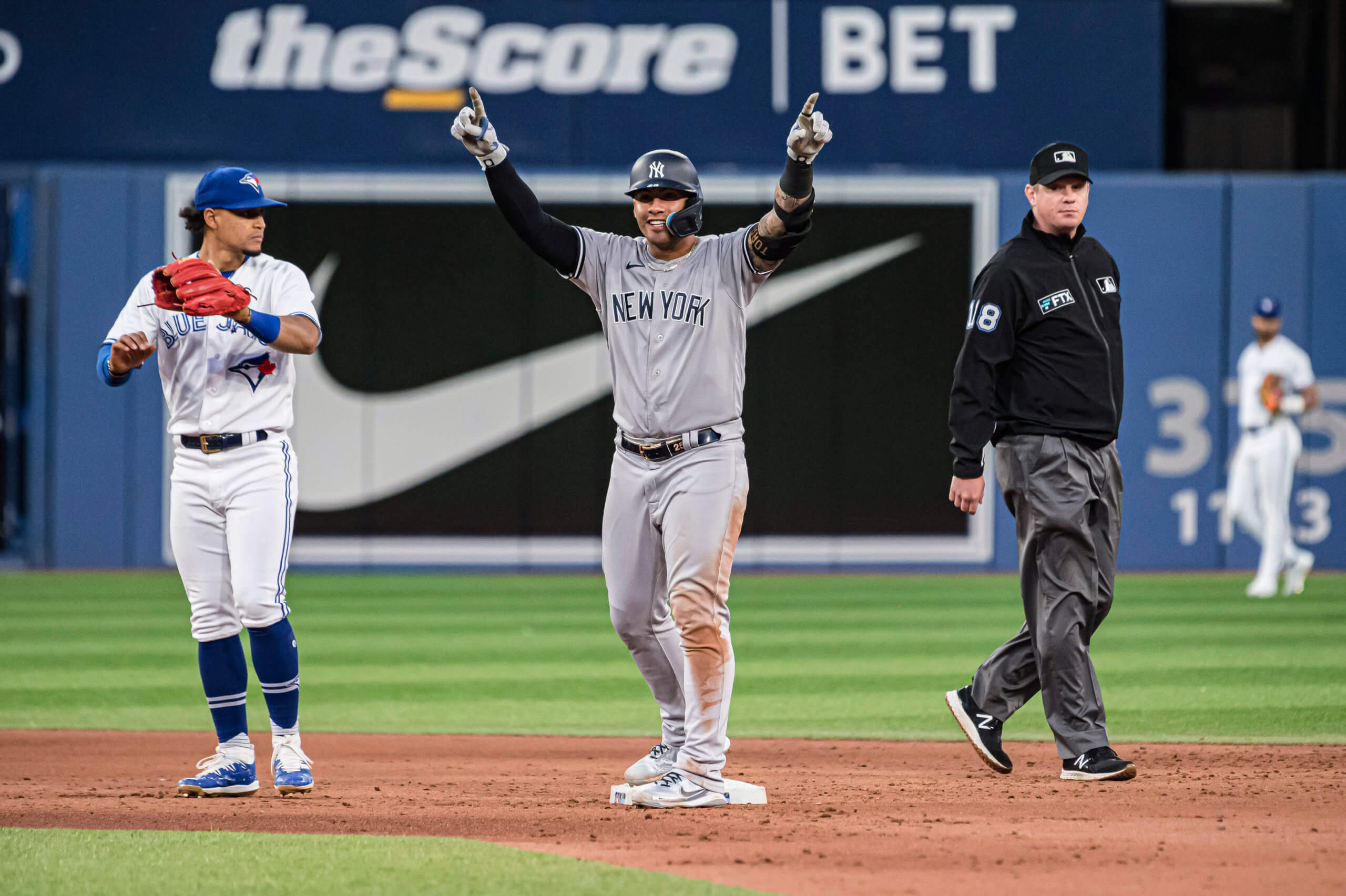 A trainer helps New York Yankees' Oswald Peraza off the field after he was  hurt during the ninth inning of a baseball game against the Cleveland  Guardians, Wednesday, May 3, 2023, in