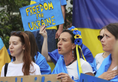 Protestors in support of Ukraine stand with signs and flags during a demonstration outside of an EU summit in Brussels on June 23.