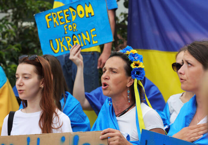 Protestors in support of Ukraine stand with signs and flags during a demonstration outside of an EU summit in Brussels on June 23.