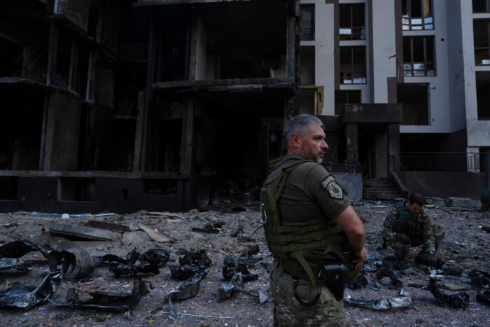Servicemen work at the scene of a residential building following explosions, in Kyiv, Ukraine, Sunday, June 26, 2022. Several explosions rocked the west of the Ukrainian capital in the early hours of Sunday morning, with at least two residential buildings struck, according to Kyiv mayor Vitali Klitschko.