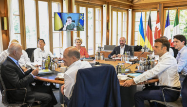 From front center clockwise, Germany's Chancellor Olaf Scholz, US President Joe Biden, Britain's Prime Minister Boris Johnson, Japan's Prime Minister Fumio Kishida, European Commission President Ursula von der Leyen, European Council President Charles Michel, Italy's Prime Minister Mario Draghi, Canada's Prime Minister Justin Trudeau and France's President Emmanuel Macron have taken seat at a round table as Ukraine's President Volodymyr Zelensky addresses the G7 leaders via video link during their working session at Castle Elmau in Kruen, near Garmisch-Partenkirchen, Germany, on Monday, June 27, 2022. The Group of Seven leading economic powers are meeting in Germany for their annual gathering Sunday through Tuesday.