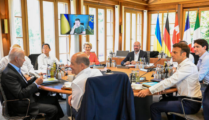 From front center clockwise, Germany's Chancellor Olaf Scholz, US President Joe Biden, Britain's Prime Minister Boris Johnson, Japan's Prime Minister Fumio Kishida, European Commission President Ursula von der Leyen, European Council President Charles Michel, Italy's Prime Minister Mario Draghi, Canada's Prime Minister Justin Trudeau and France's President Emmanuel Macron have taken seat at a round table as Ukraine's President Volodymyr Zelensky addresses the G7 leaders via video link during their working session at Castle Elmau in Kruen, near Garmisch-Partenkirchen, Germany, on Monday, June 27, 2022. The Group of Seven leading economic powers are meeting in Germany for their annual gathering Sunday through Tuesday.