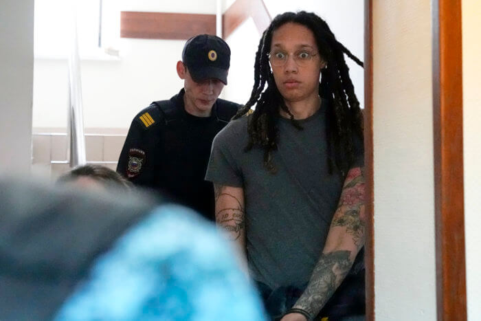 WNBA star and two-time Olympic gold medalist Brittney Griner is escorted to a courtroom for a hearing, in Khimki just outside Moscow, Russia, Monday, June 27, 2022. More than four months after she was arrested at a Moscow airport for cannabis possession, American basketball star Brittney Griner is to appear in court Monday for a preliminary hearing ahead of her trial.
