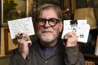 Jimmy Kaston holding some of the customized cue cards for his upcoming show