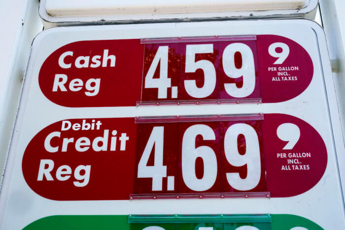 Gas prices are displayed at a filling station.