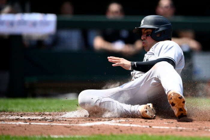 Yankees' Jose Trevino slides home to score on a double by DJ LeMahieu during the 3rd inning.