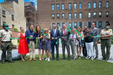 Cutting the ribbon at Manuel Plaza.