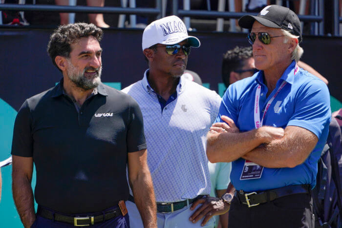 Yasir Al-Rumayyan, governor of Saudi Arabia's Public Investment Fund, left, Majed Al-Sorour, CEO of Golf Saudi, center, and Greg Norman, CEO of LIV Golf, watch at the first tee during the second round of the Bedminster Invitational LIV Golf tournament in Bedminster.