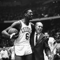 Bill Russell, left, star of the Boston Celtics is congratulated by coach Arnold "Red" Auerbach after scoring his 10,000th point in the NBA game against the Baltimore Bullets in Boston Garden in 1964.