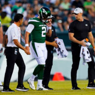 Jets' Zach Wilson is taken off the field after an injury during the first half of a preseason game against the Eagles on Friday.