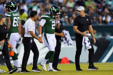 Jets' Zach Wilson is taken off the field after an injury during the first half of a preseason game against the Eagles on Friday.