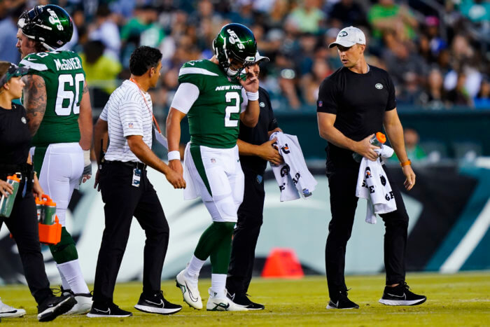 Jets' Zach Wilson is taken off the field after an injury during the first half of a preseason game against the Eagles on Friday.