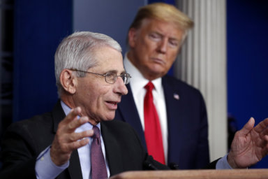 President Donald Trump watches as Dr. Anthony Fauci, director of the National Institute of Allergy and Infectious Diseases, speaks about the coronavirus in the James Brady Press Briefing Room of the White House, April 22, 2020, in Washington. Fauci, the nation's top infectious disease expert who became a household name, and the subject of partisan attacks, during the COVID-19 pandemic, announced Monday he will depart the federal government in December after more than 5 decades of service.