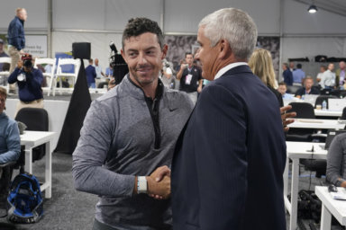 Rory McIlroy, left, shakes hands with PGA Tour Commissioner Jay Monahan after a press conference at East Lake Golf Club.