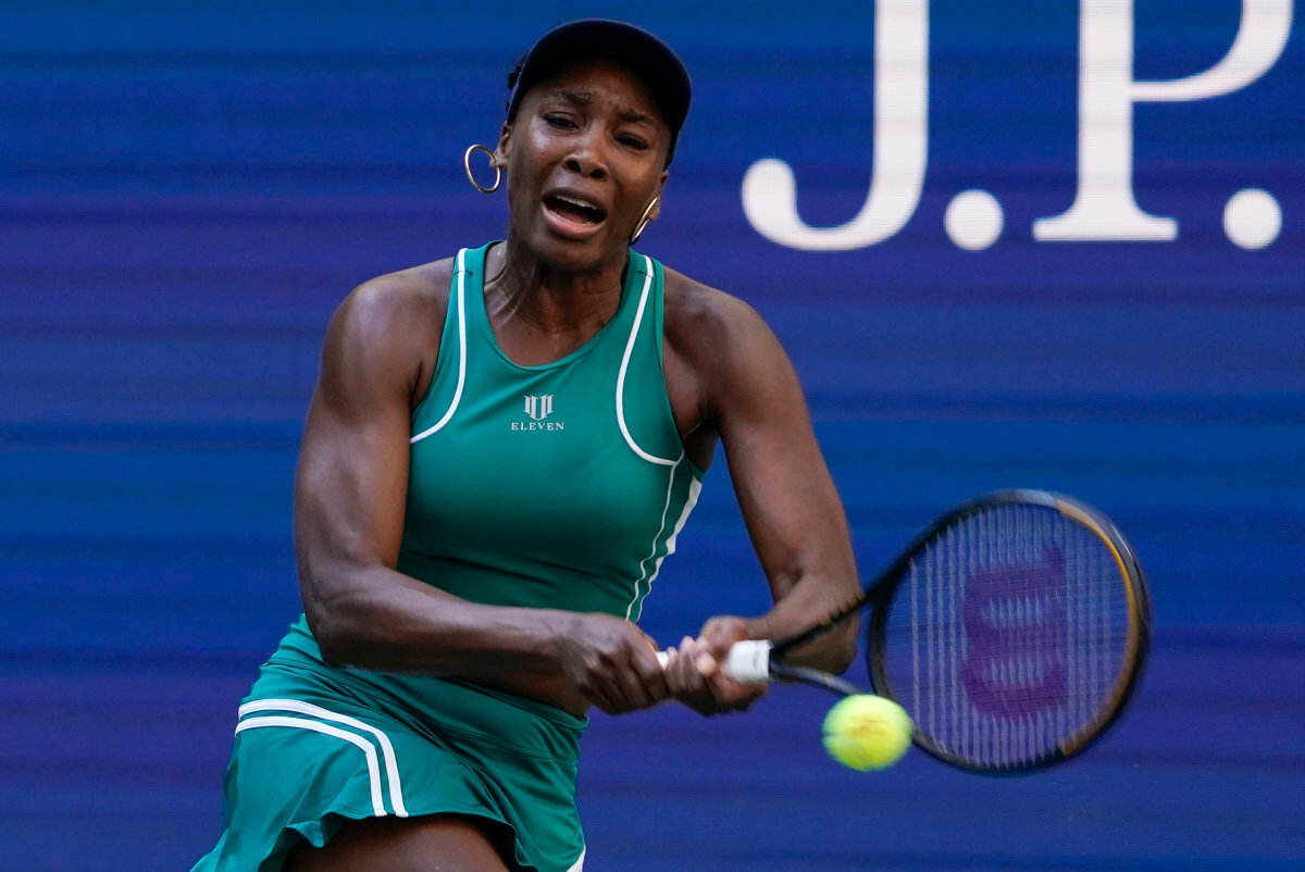 Venus Williams, of the United States, returns a shot to Alison Van Uytvanck, of Belgium, during the first round of the US Open tennis championships.