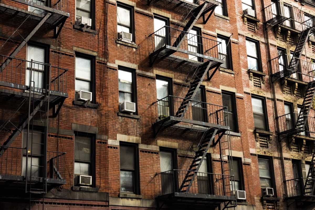 Close-up view of New York City style apartment buildings with emergency stairs along Mott Street in Chinatown neighborhood of Manhattan, New York, United States.