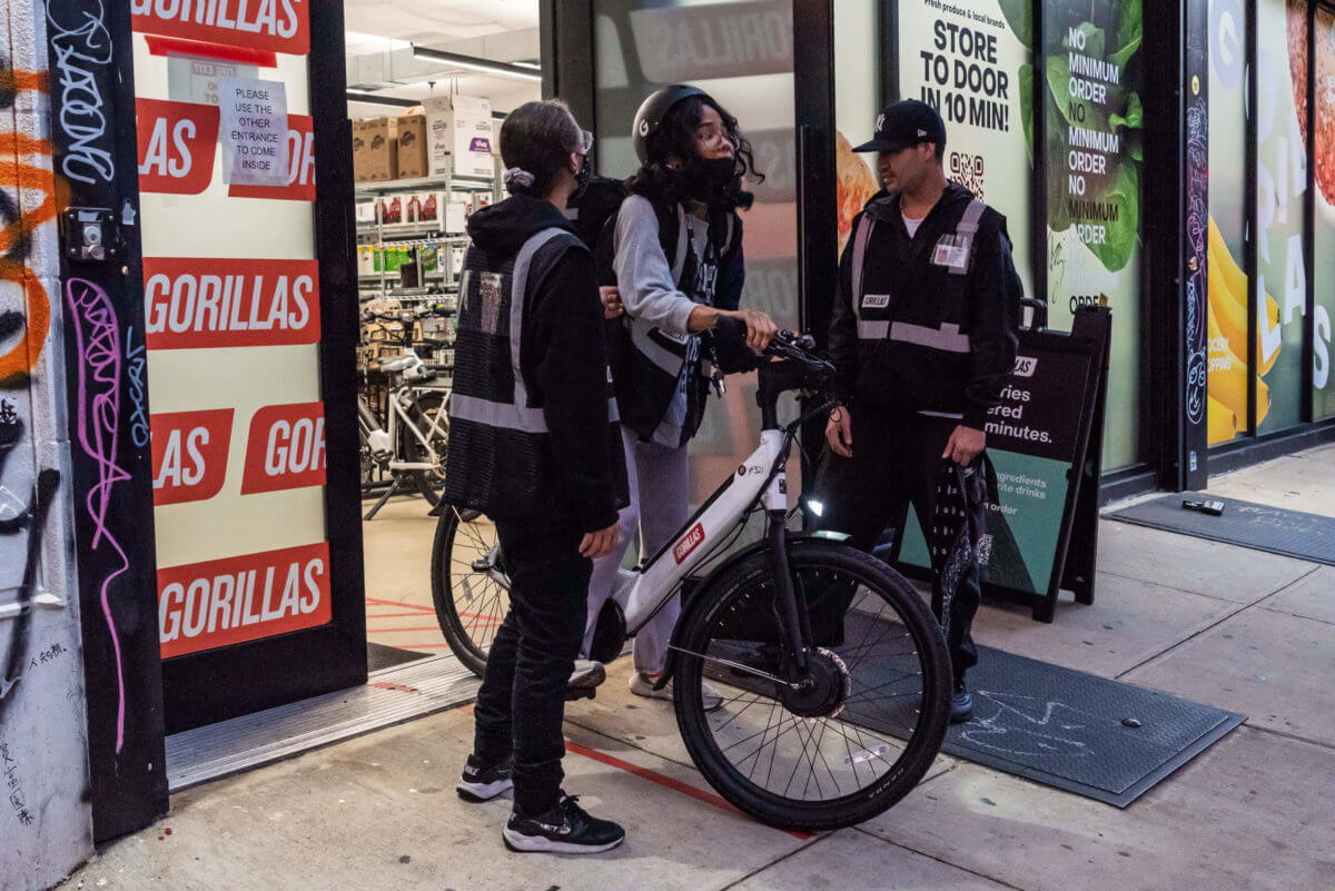 gorillas delivery worker riding out of dark store