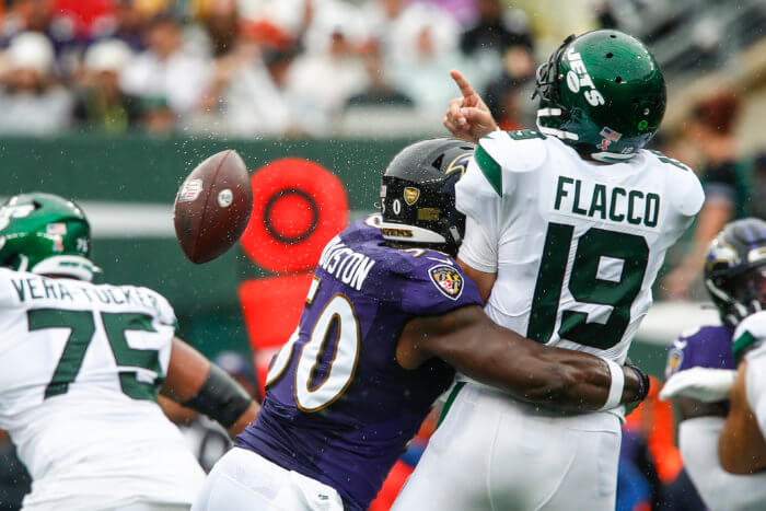 Ravens' Justin Houston hits Jets quarterback Joe Flacco as he throws a pass during the first half of their Week 1 matchup.