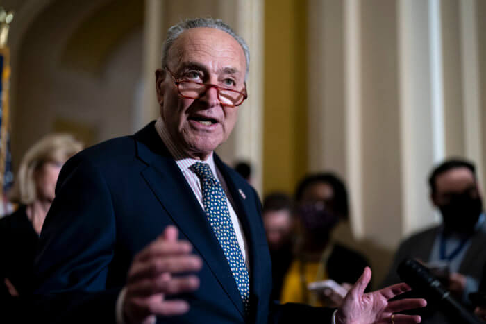 Senate Majority Leader Chuck Schumer speaks to reporters at the Capitol in Washington.