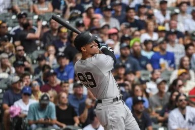 Yankees' Aaron Judge hits his fifty eighth homerun during the third inning of a baseball game against the Milwaukee Brewers.