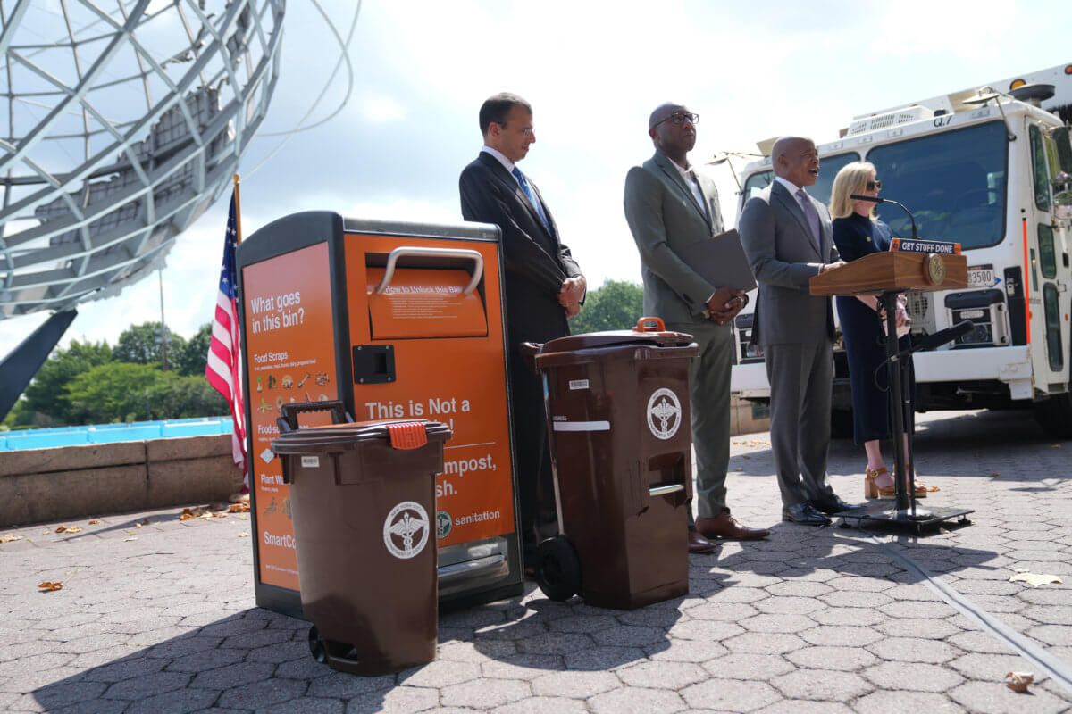 Mayor Adams stands with city officials to announce the Queens organics composting program