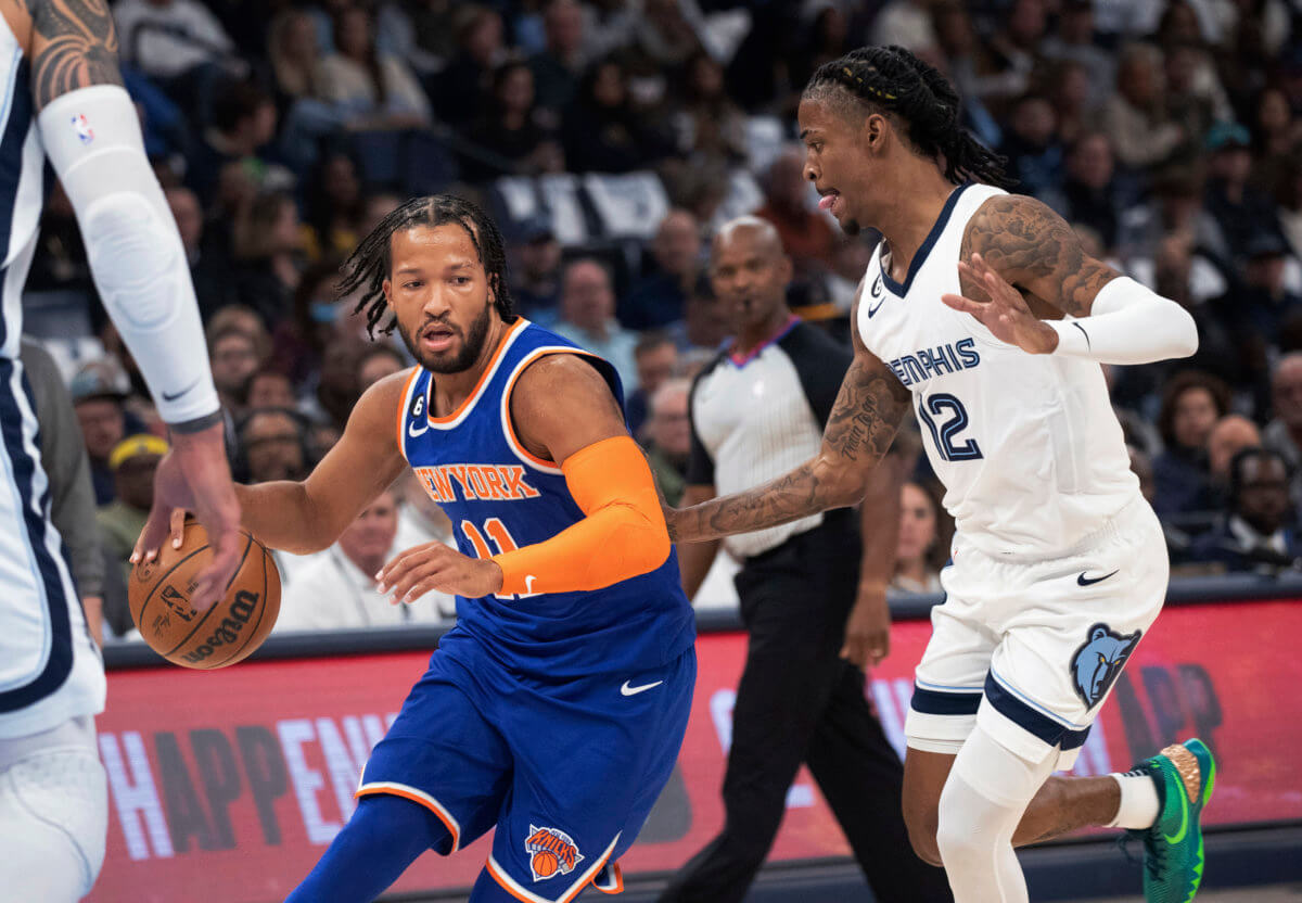 New York Knicks guard Jalen Brunson (11) dribbles the ball while defended by Memphis Grizzlies guard Ja Morant (12) during the first half.