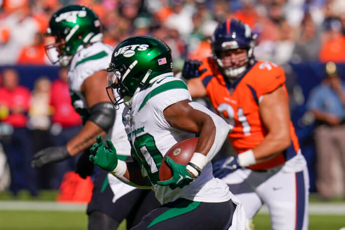 Jets running back Breece Hall runs for the end zone against the Denver Broncos during the first half.