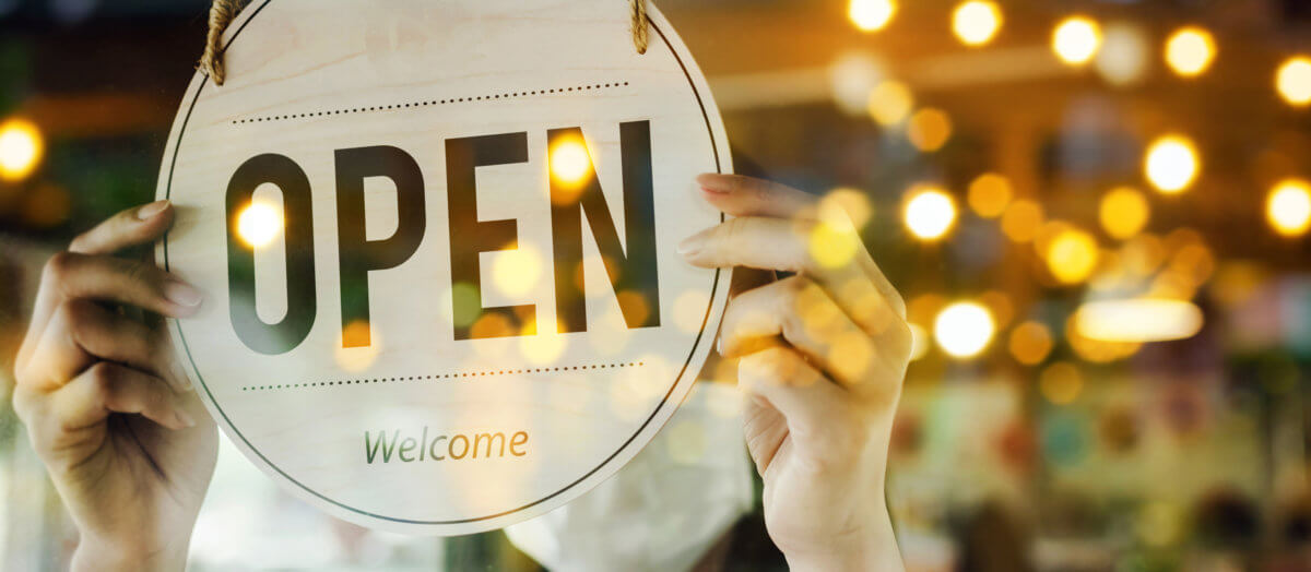 wide banner. waitress staff woman wearing protection face mask turning open sign board on glass door in cafe coffee shop, hotel service, cafe restaurant, retail store, small business owner concept