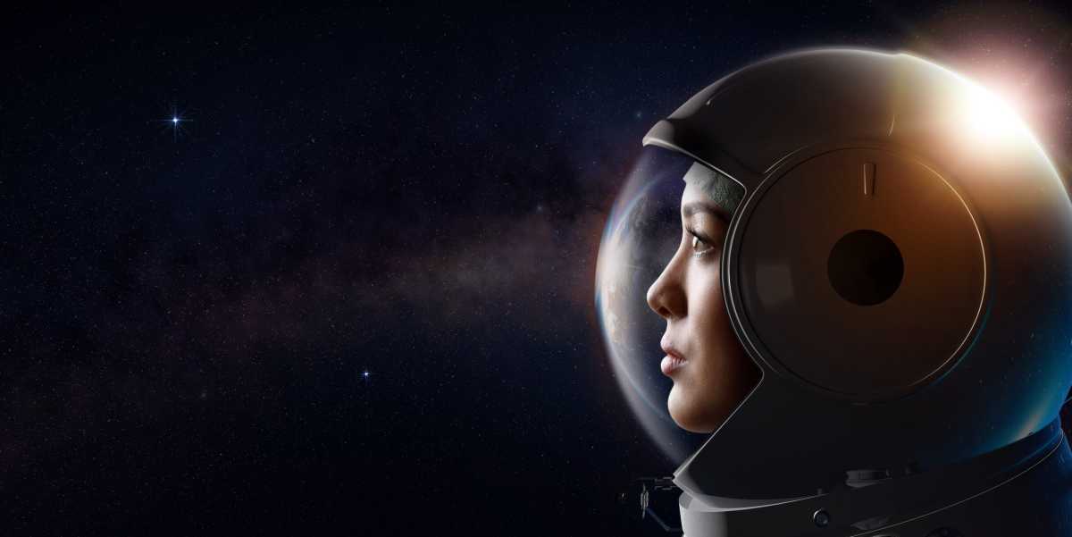 Portrait of female cosmonaut in the outer space.