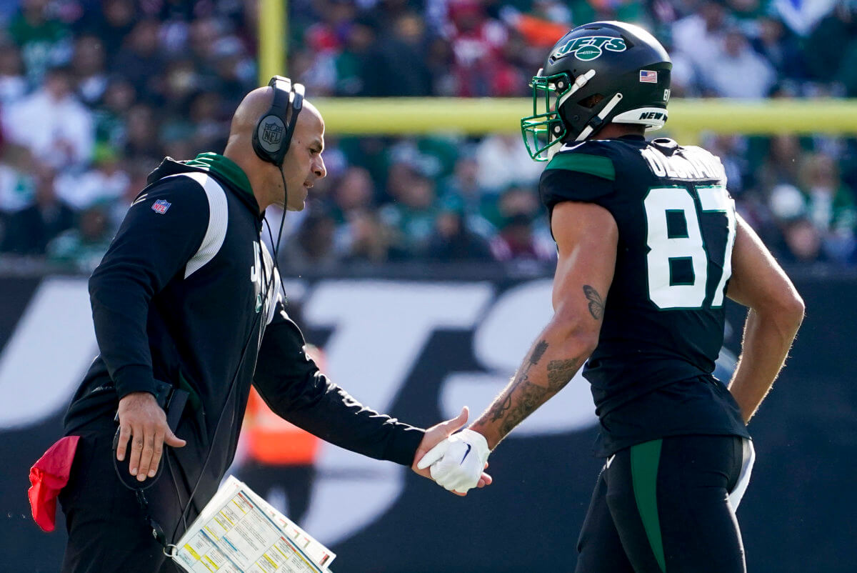 New York Jets head coach Robert Saleh congratulates New York Jets tight end C.J. Uzomah (87) after the Jets scored a touchdown against the New England Patriots.