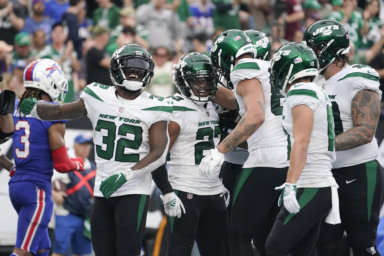 New York Jets running back James Robinson (23) celebrates with teammates after scoring a touchdown during the second half.