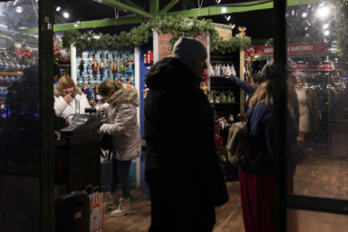 People shop for Christmas trinkets in Bryant Park's Winter Village holiday market