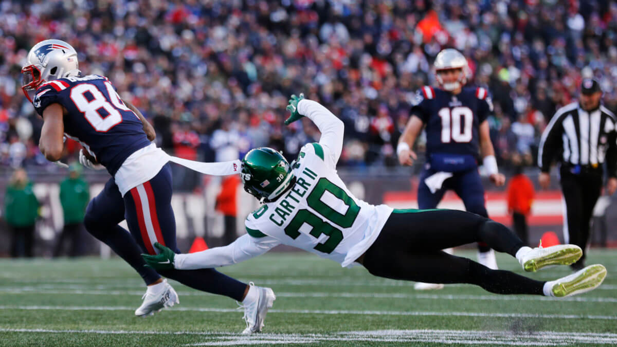Jets cornerback Michael Carter II dives but misses the tackle after a reception by Patriots wide receiver Kendrick Bourne.