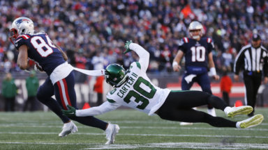 Jets cornerback Michael Carter II dives but misses the tackle after a reception by Patriots wide receiver Kendrick Bourne.