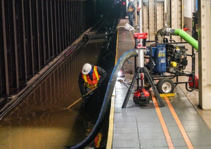 MTA crews work to clear the flooding.