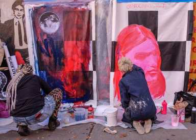 Artists and work, canvases taped to the wall.  Artist Erin Ko and Bree Chapin.