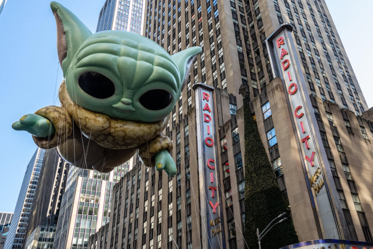 The Grogu balloon floats passed Radio City Music Hall during the 2022 Macy's Thanksgiving Day Parade.