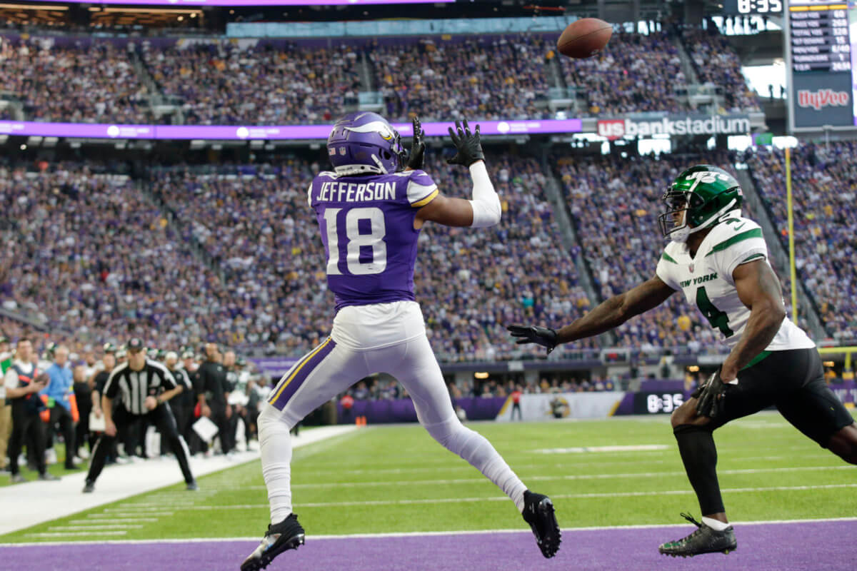 Vikings wide receiver Justin Jefferson catches a 10-yard touchdown pass ahead of Jets cornerback D.J. Reed.