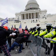 Insurrectionists loyal to President Donald Trump try to break through a police barrier, Wednesday, Jan. 6, 2021, at the Capitol in Washington