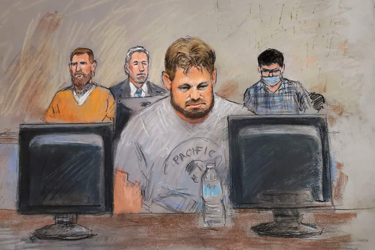 In this courtroom drawing, from left, Brandon Caserta with his attorney Michael Darragh Hills, defendants Adam Fox, center, and Ty Garbin appear during a hearing in federal court.
