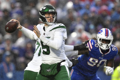 New York Jets quarterback Mike White winds up to pass.
